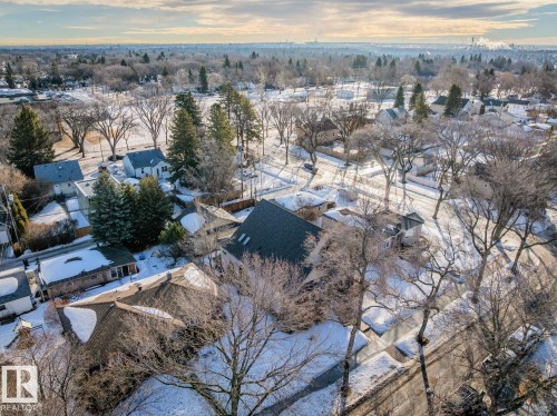 Aerial view of the property and its surrounding neighborhood, featuring mature trees and snow-covered grounds - 11409 63 Street Nw, Edmonton, AB - Outdoor With View