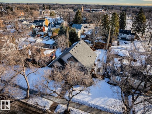 Aerial view of the property and its surrounding neighborhood, featuring a sloped roof and a visible street and sidewalk - 11409 63 Street Nw, Edmonton, AB - Outdoor With View
