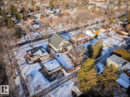 The property is situated in a neighborhood with tree-lined streets and features a detached garage - 11409 63 Street Nw, Edmonton, AB - Outdoor With View