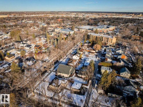 An aerial view of the property and surrounding neighborhood, featuring a mix of residential homes and larger buildings - 11409 63 Street Nw, Edmonton, AB - Outdoor With View
