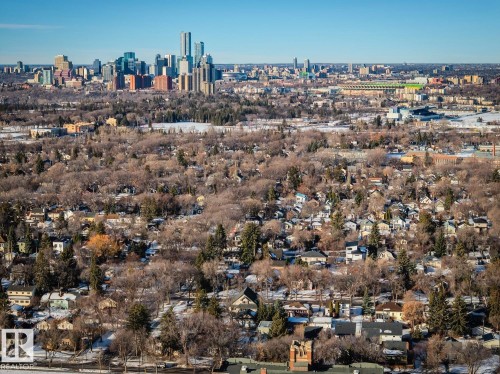 Aerial view showcasing a residential area with a prominent city skyline in the background - 11409 63 Street Nw, Edmonton, AB - Outdoor With View