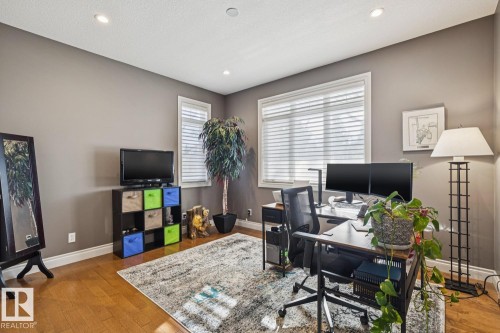 This room features hardwood flooring, recessed lighting, and windows with blinds - 11409 63 Street Nw, Edmonton, AB - Indoor Photo Showing Office