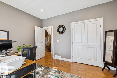 This room features hardwood flooring, light grey walls, and white trim - 11409 63 Street Nw, Edmonton, AB - Indoor Photo Showing Office