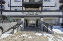 The property features a building entrance with glass doors, exterior steps, and handrails - 314 2430 Guardian Road, Edmonton, AB  - Outdoor With Balcony With Exterior 