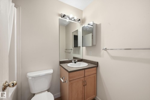 The bathroom features a vanity with a countertop, a sink, and cabinet storage - 314 2430 Guardian Road, Edmonton, AB - Indoor Photo Showing Bathroom