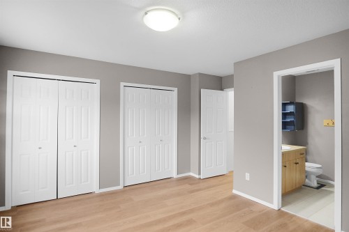 This room features light wood-style flooring and a light-colored ceiling - 13 3751 12 Street, Edmonton, AB - Indoor Photo Showing Other Room