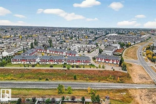 Aerial view highlighting the property's location within a developed community, featuring established residential areas, roadways, and green spaces - 13 3751 12 Street, Edmonton, AB - Outdoor With View