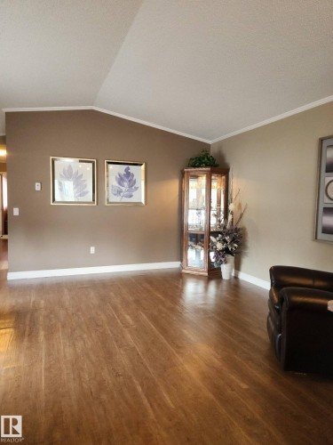 Living area featuring hardwood flooring, vaulted ceilings, and crown molding - 46 Willow Park Estates, Leduc, AB - Indoor