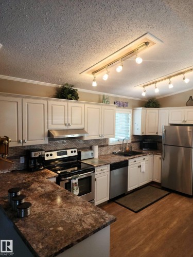 A white vertical heating and cooling unit is present - 46 Willow Park Estates, Leduc, AB - Indoor Photo Showing Other Room