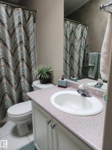 The property includes a detached shed with a double door entry and a light-colored exterior - 46 Willow Park Estates, Leduc, AB - Outdoor