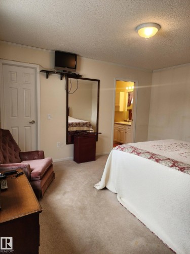 The property features white siding, a prominent bay window, and a deck with dark railings - 46 Willow Park Estates, Leduc, AB - Outdoor