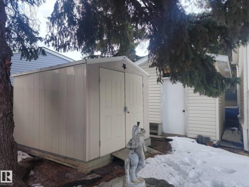 The property includes a detached shed with a double door entry and a light-colored exterior - 46 Willow Park Estates, Leduc, AB - Outdoor