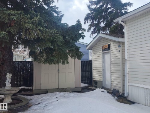 The property features a utility shed with double doors and an additional exterior shed with a single door, both providing practical outdoor storage solutions - 46 Willow Park Estates, Leduc, AB - Outdoor