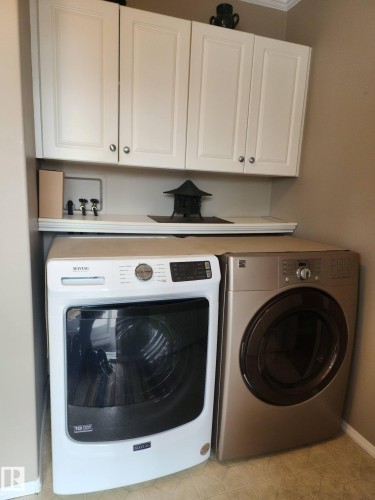 Laundry area featuring white cabinetry, a countertop, and a tile floor - 46 Willow Park Estates, Leduc, AB - Indoor Photo Showing Laundry Room