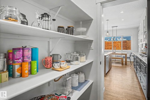 The property features a well-organized pantry with white shelving, offering ample storage space - 34 Riverhill Crescent, St. Albert, AB - Indoor Photo Showing Other Room