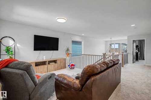 The property features an open-concept living area with light-colored walls and carpeting, offering a versatile space for relaxation - 34 Riverhill Crescent, St. Albert, AB - Indoor Photo Showing Living Room