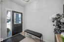 Entryway featuring a black door with a window, a sidelight, and light-colored tiled flooring - 34 Riverhill Crescent, St. Albert, AB  - Indoor Photo Showing Other Room 