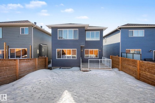 The property features blue siding, white-framed windows, and a white-railed deck - 34 Riverhill Crescent, St. Albert, AB - Outdoor With Deck Patio Veranda With Exterior