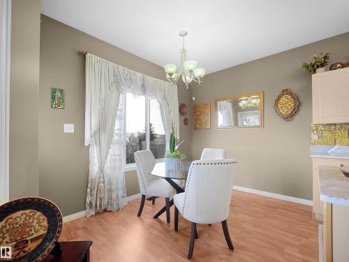 Dining room with light wood-style floors and hanging lights - 11708 10 Avenue, Edmonton, AB - Indoor Photo Showing Dining Room