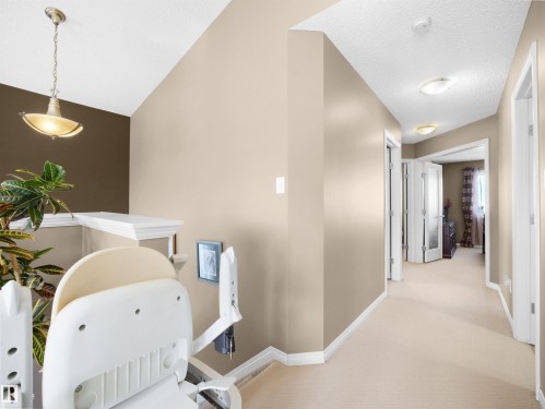 Hallway with light carpet and baseboards - 11708 10 Avenue, Edmonton, AB - Indoor
