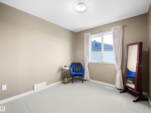 Unfurnished room with carpet floors and a textured ceiling - 11708 10 Avenue, Edmonton, AB - Indoor