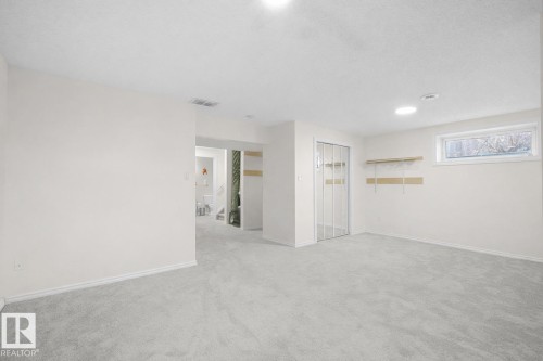 Empty room with light colored carpet and recessed lighting - 11708 10 Avenue, Edmonton, AB - Indoor