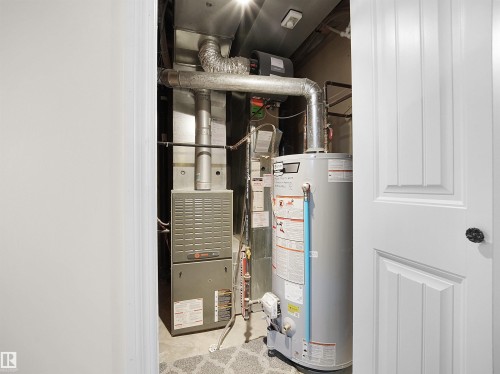 Utility room with water heater and heating unit - 11708 10 Avenue, Edmonton, AB - Indoor Photo Showing Basement