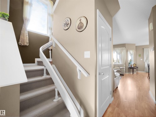 Staircase featuring wood finished floors and baseboards - 11708 10 Avenue, Edmonton, AB - Indoor Photo Showing Other Room