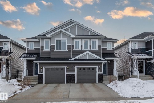 The property features a modern exterior with a grey siding facade, white trim, and a dark shingled roof - 483 Ebbers Way Nw, Edmonton, AB - Outdoor With Facade
