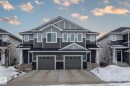 The property features a modern exterior with a grey siding facade, white trim, and a dark shingled roof - 483 Ebbers Way Nw, Edmonton, AB  - Outdoor With Facade 