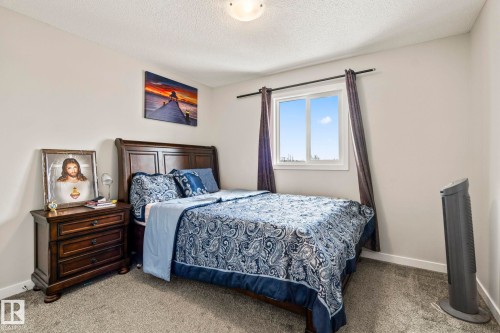 This bedroom features light-colored walls and grey carpet flooring - 483 Ebbers Way Nw, Edmonton, AB - Indoor Photo Showing Bedroom