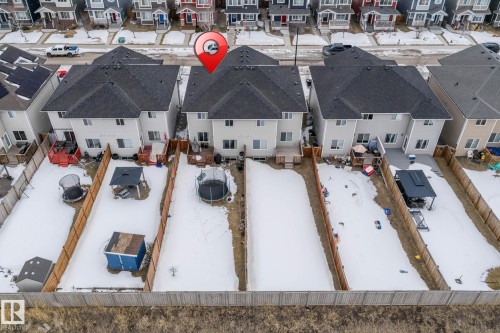 The property features a private fenced yard with a deck - 483 Ebbers Way Nw, Edmonton, AB - Outdoor With View