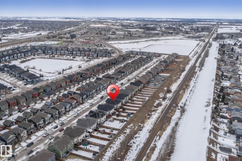 Aerial view showcasing the property within a residential area, surrounded by other homes and streets - 483 Ebbers Way Nw, Edmonton, AB - Outdoor With View