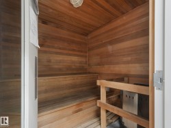 The property includes a sauna with extensive wood paneling and wood benches, featuring a metal heater unit - 