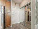 Entryway featuring tiled flooring, a white paneled door, and a mirrored closet with sliding doors - 412 12408 15 Avenue, Edmonton, AB  - Indoor Photo Showing Other Room 