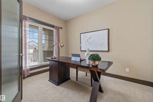 This bright room features a large window with blinds and sheer curtains, providing natural light - 1014 Hope Road, Edmonton, AB - Indoor Photo Showing Office