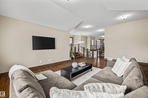 The property features rich hardwood flooring throughout the main living areas, complemented by light-colored walls - 1014 Hope Road, Edmonton, AB - Indoor Photo Showing Living Room