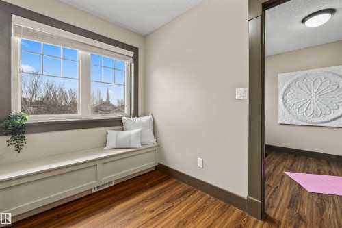 This room features wood flooring, a built-in window bench, and large windows with blinds - 1014 Hope Road, Edmonton, AB - Indoor Photo Showing Other Room