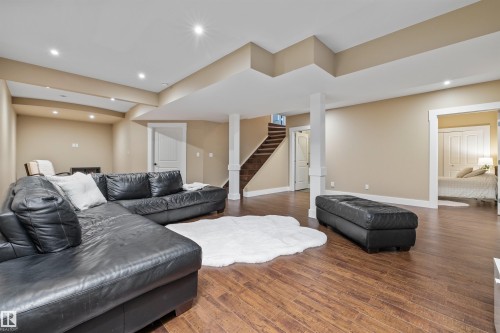 Spacious second living area featuring durable flooring, recessed lighting, and access to a staircase with wood treads - 1014 Hope Road, Edmonton, AB - Indoor Photo Showing Other Room