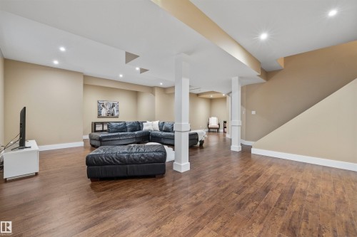 Spacious second living area featuring wood-style flooring, recessed lighting, and support columns - 1014 Hope Road, Edmonton, AB - Indoor