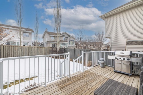 Spacious outdoor deck with white railings and wood flooring, providing access to the backyard - 1014 Hope Road, Edmonton, AB - Outdoor With Deck Patio Veranda With Exterior