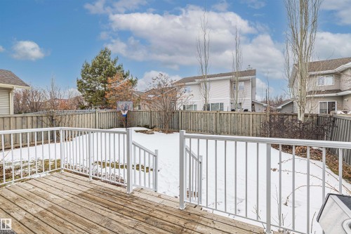 The property includes a wooden deck with white railings, offering views of a fenced yard - 1014 Hope Road, Edmonton, AB - Outdoor