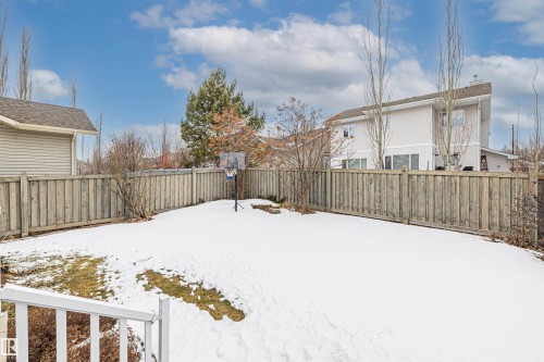 The property features a private yard with a wooden fence and a basketball hoop - 1014 Hope Road, Edmonton, AB - Outdoor