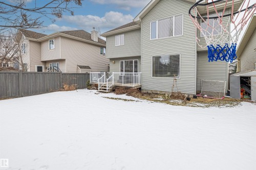 The property features a fenced yard, a rear deck with white railings, and an exterior with siding - 1014 Hope Road, Edmonton, AB - Outdoor