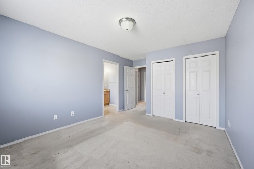 The property features light blue walls and neutral carpeting, creating a serene ambiance - 53 287 Macewan Road, Edmonton, AB - Indoor