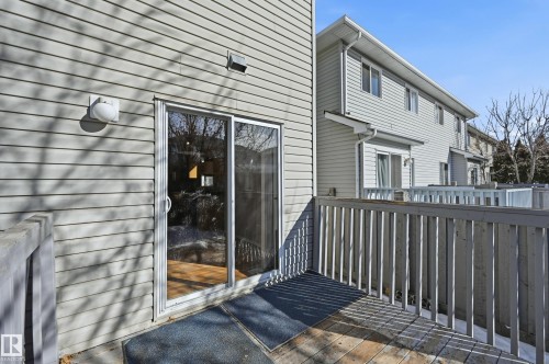 The property features a deck with a wooden railing, providing outdoor space - 53 287 Macewan Road, Edmonton, AB - Outdoor With Exterior