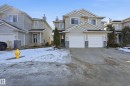 The property features a two-story exterior with light-colored siding and a two-car garage - 53 287 Macewan Road, Edmonton, AB  - Outdoor With Facade 