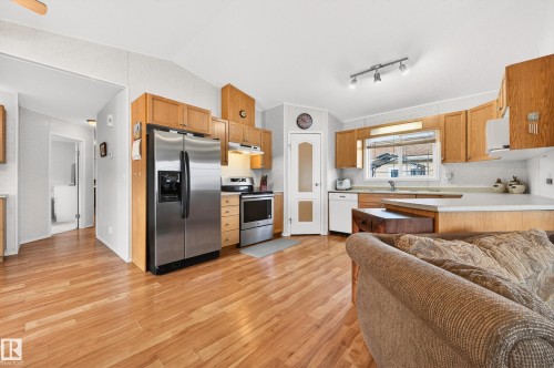 Well-appointed kitchen featuring hardwood flooring, stainless steel appliances, a window above the sink, and ample wood cabinetry - 1727 Jubilee Loop, Sherwood Park, AB - Indoor Photo Showing Kitchen With Stainless Steel Kitchen