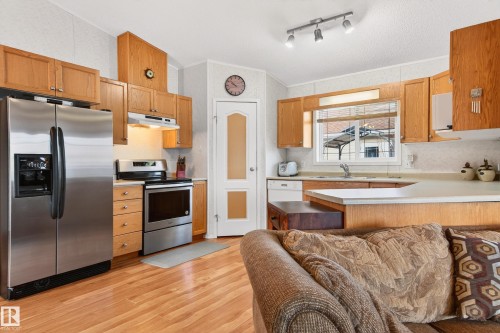 The kitchen features wood cabinetry, stainless steel appliances, and a light-colored countertop - 1727 Jubilee Loop, Sherwood Park, AB - Indoor Photo Showing Kitchen With Stainless Steel Kitchen