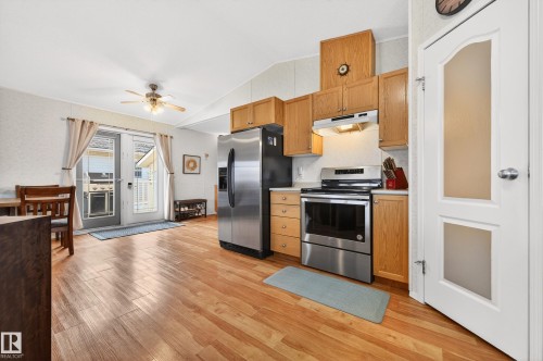 The kitchen features light wood cabinetry, stainless steel appliances, and a light-colored countertop - 1727 Jubilee Loop, Sherwood Park, AB - Indoor Photo Showing Kitchen